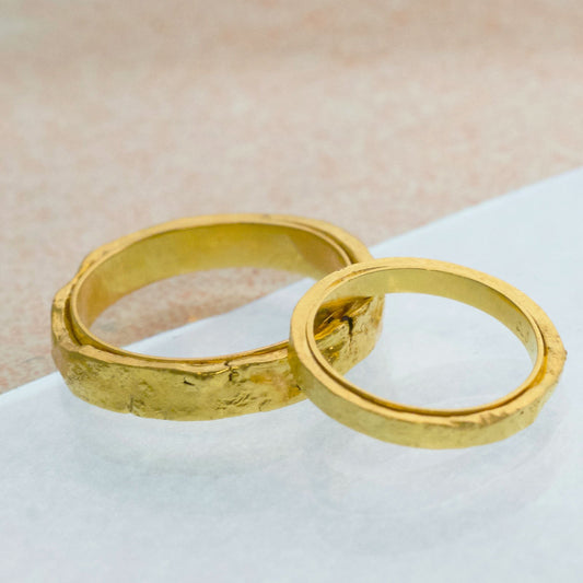 Two beautiful and unusual wedding bands, with rough organic texture. Made in recycled silver plated with 24ct gold. 