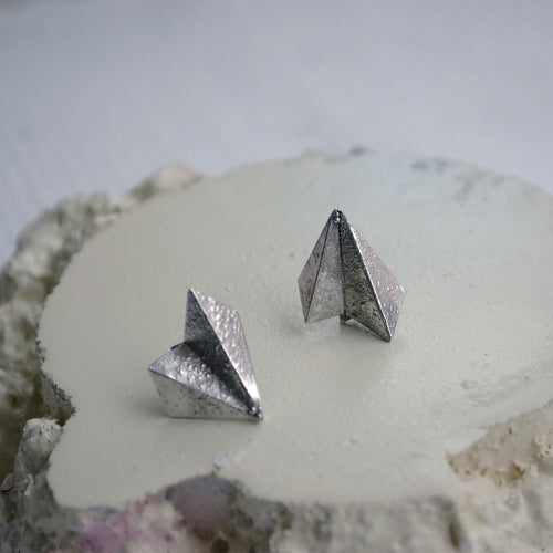 Handmade, fan shaped geometric stud earrings. Origami paper style with rough, raw rustic, surface texture. Made in Copenhagen recycled silver. 